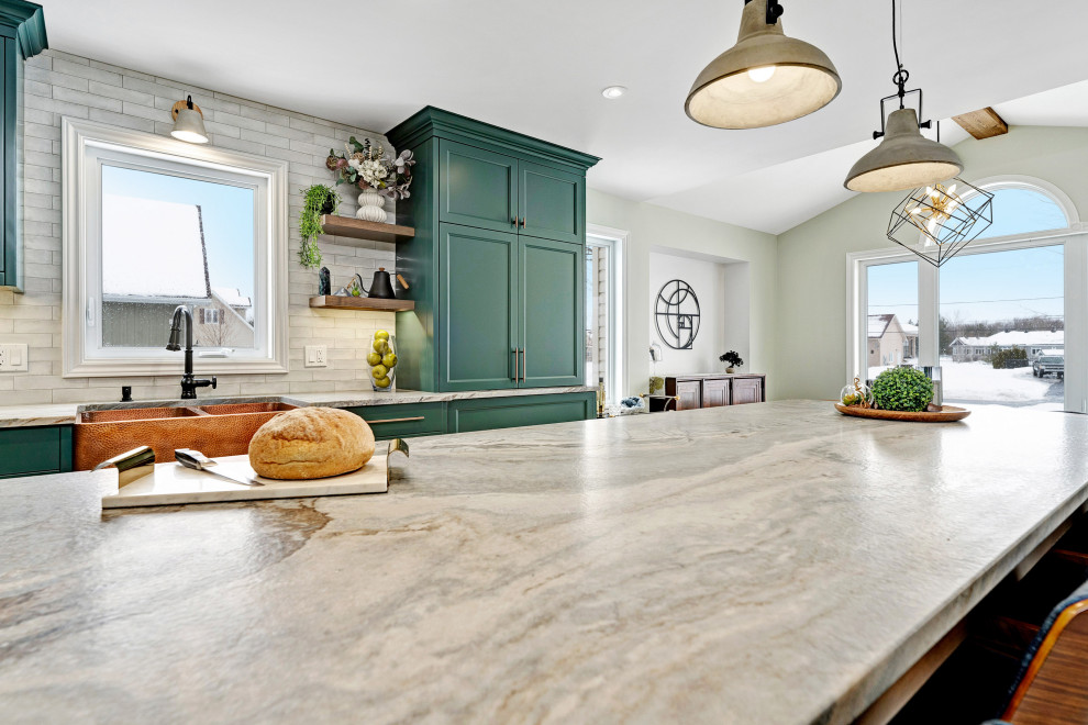 Inspiration for a large traditional l-shaped eat-in kitchen in Ottawa with a farmhouse sink, recessed-panel cabinets, green cabinets, quartzite benchtops, white splashback, porcelain splashback, black appliances, porcelain floors, with island, white floor and grey benchtop.