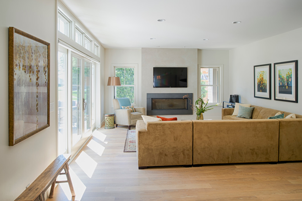 Photo of a beach style open concept family room in Minneapolis with beige walls and light hardwood floors.