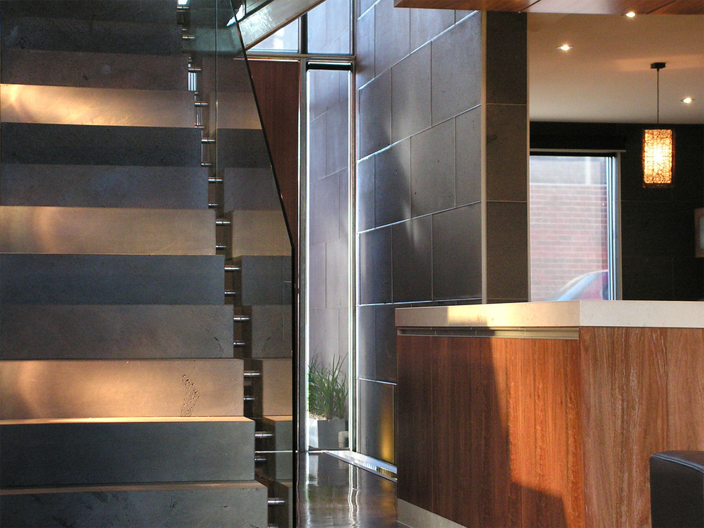 Design ideas for a large l-shaped staircase in Other with glass railing.