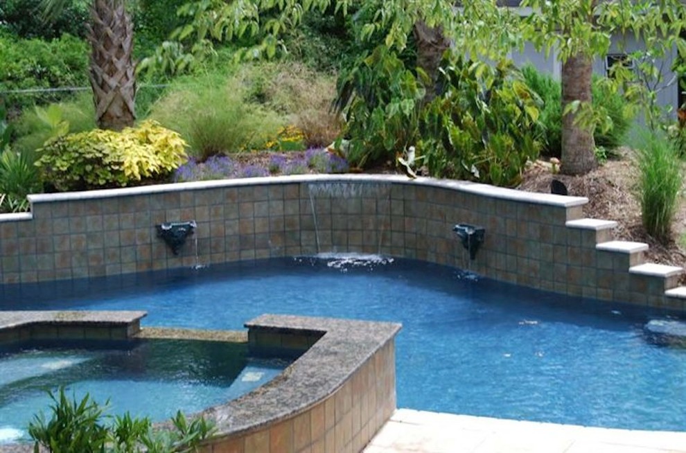 Inspiration for a mid-sized backyard stone and rectangular natural pool fountain remodel