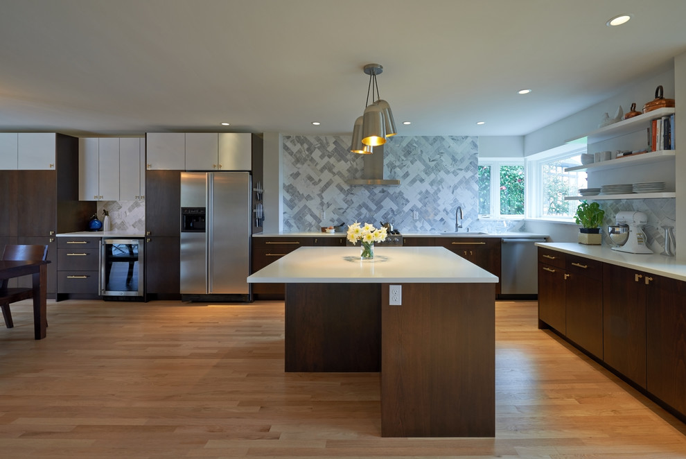 Large midcentury l-shaped eat-in kitchen in Seattle with with island, a single-bowl sink, flat-panel cabinets, multi-coloured splashback, stainless steel appliances, quartz benchtops, dark wood cabinets, stone tile splashback and light hardwood floors.
