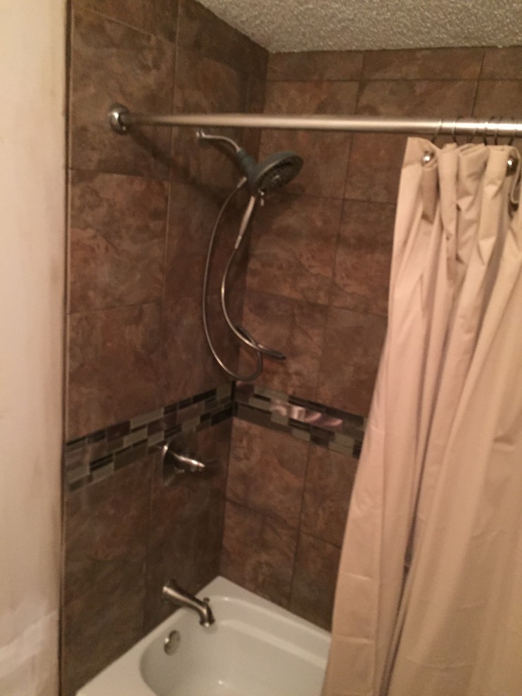 Example of a mid-sized transitional kids' brown tile and porcelain tile alcove bathtub design