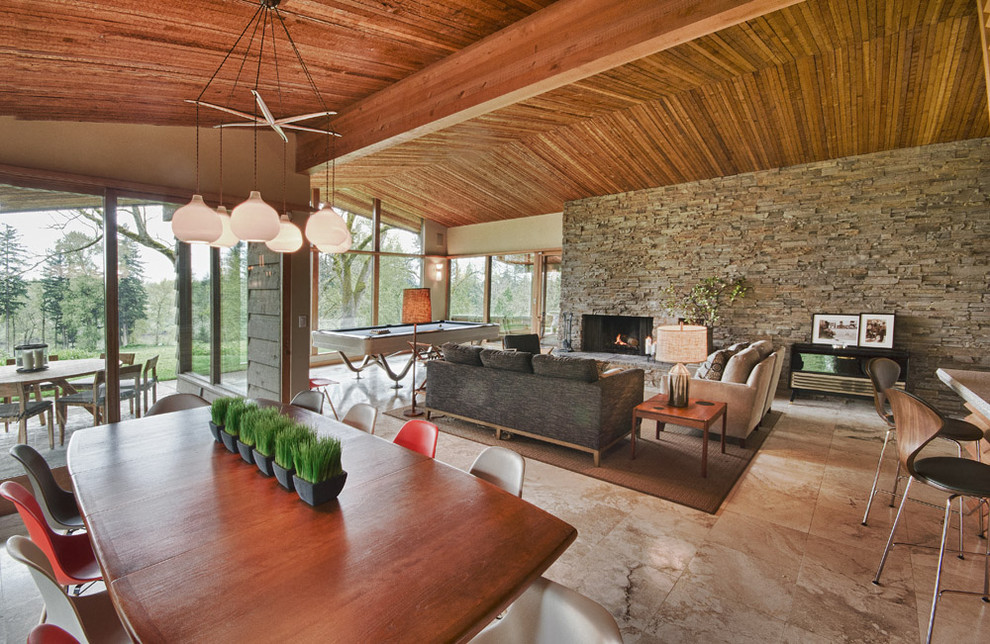 Midcentury open concept living room in Portland with a standard fireplace and a stone fireplace surround.