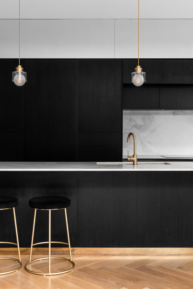 Photo of a mid-sized contemporary galley eat-in kitchen in Melbourne with marble benchtops, marble splashback, medium hardwood floors and with island.
