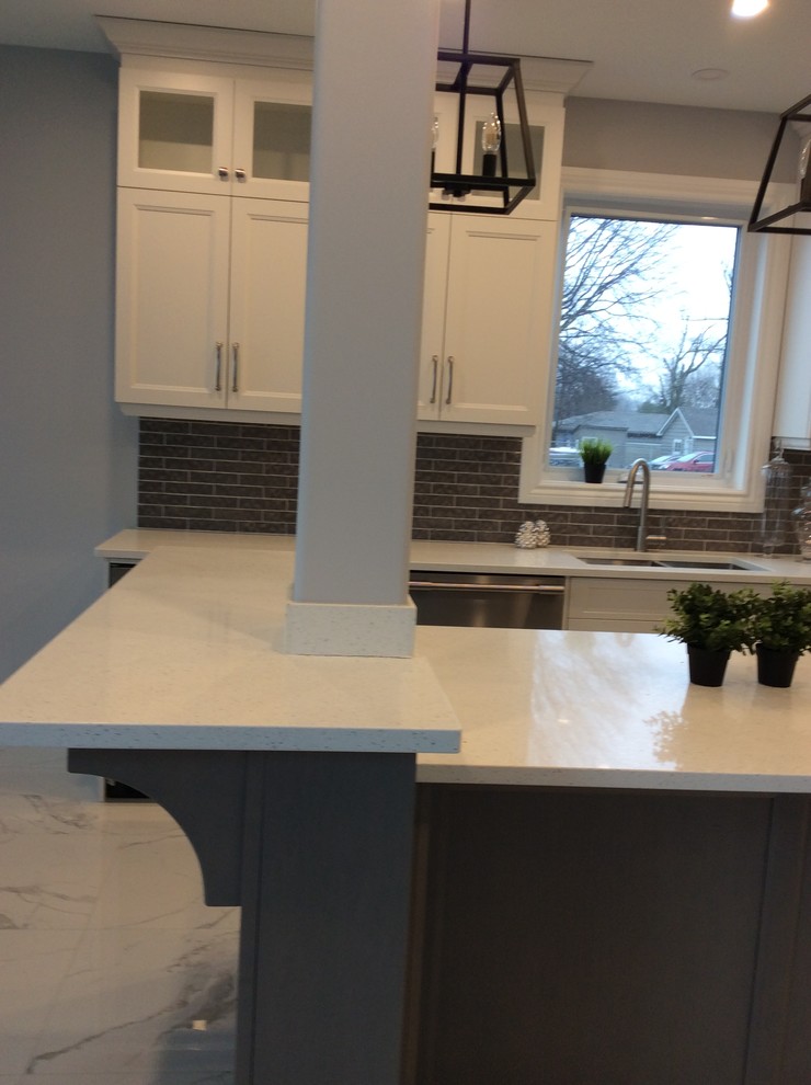 Kitchen - kitchen idea with an undermount sink, quartz countertops, an island and white countertops