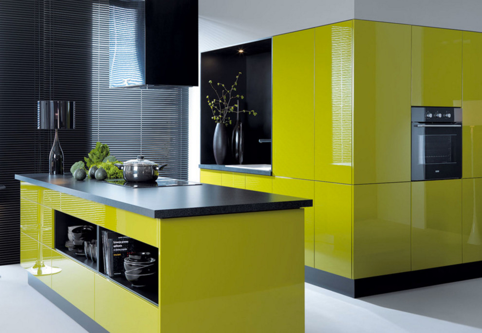 Eat-in kitchen - large modern single-wall concrete floor and gray floor eat-in kitchen idea in New York with a drop-in sink, flat-panel cabinets, yellow cabinets, soapstone countertops, black appliances and an island