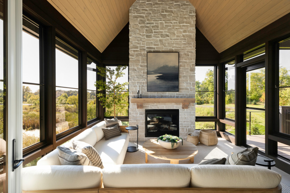 Transitional porch idea in Minneapolis with a roof extension