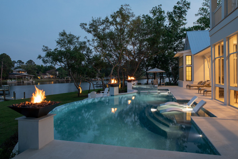 Inspiration for a large transitional backyard concrete paver and custom-shaped infinity hot tub remodel