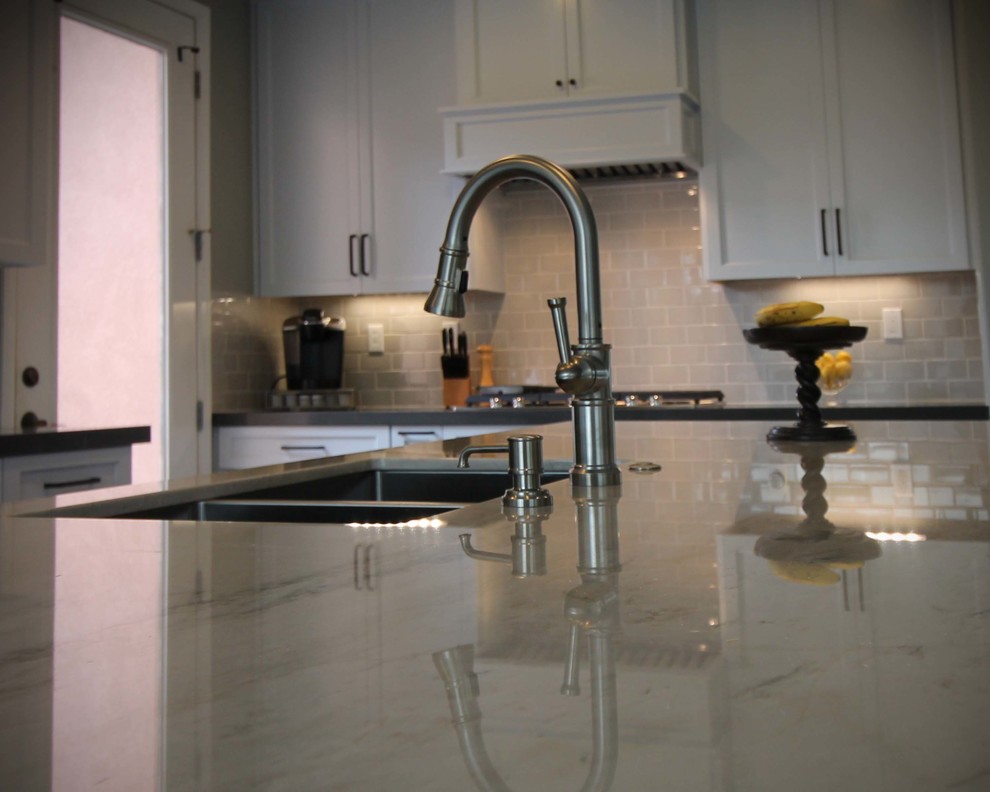 Open concept kitchen - mid-sized transitional l-shaped porcelain tile open concept kitchen idea in Sacramento with an undermount sink, shaker cabinets, gray cabinets, quartzite countertops, gray backsplash, ceramic backsplash, stainless steel appliances and an island