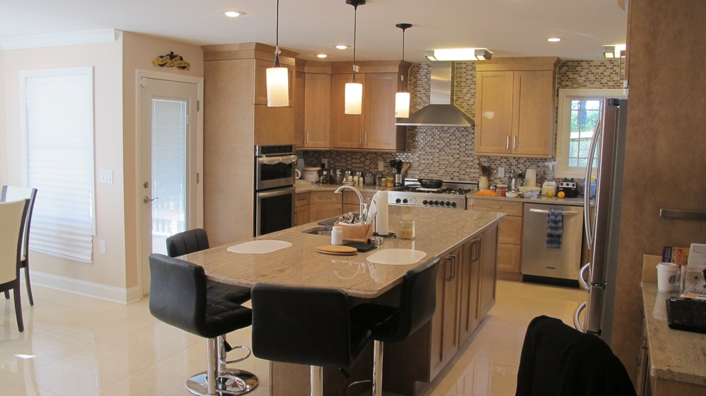 Example of a mid-sized transitional u-shaped concrete floor and beige floor open concept kitchen design in New York with an undermount sink, recessed-panel cabinets, light wood cabinets, granite countertops, multicolored backsplash, mosaic tile backsplash, stainless steel appliances, an island and beige countertops