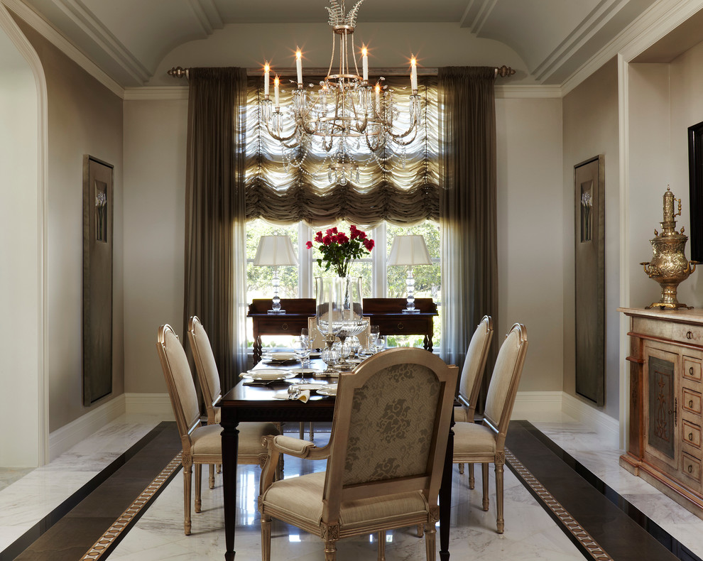 This is an example of a mid-sized traditional separate dining room in Miami with beige walls, marble floors, no fireplace and white floor.