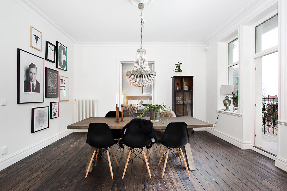 Photo of a large scandinavian separate dining room in Malmo with white walls, dark hardwood floors and no fireplace.
