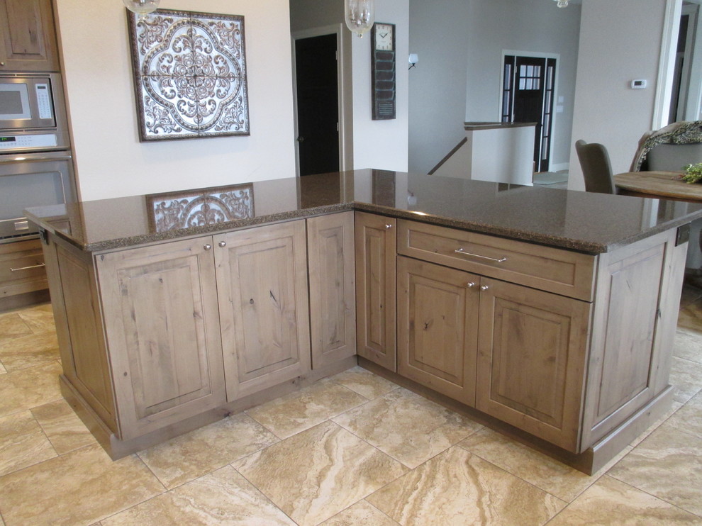 Open concept kitchen - mid-sized transitional l-shaped ceramic tile open concept kitchen idea with an undermount sink, raised-panel cabinets, beige backsplash, subway tile backsplash, stainless steel appliances, an island, medium tone wood cabinets and quartz countertops