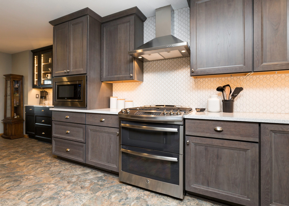 Eat-in kitchen - mid-sized transitional l-shaped vinyl floor and gray floor eat-in kitchen idea with a farmhouse sink, recessed-panel cabinets, gray cabinets, quartz countertops, white backsplash, ceramic backsplash, stainless steel appliances, no island and white countertops