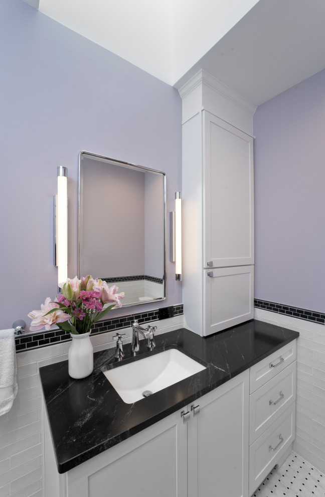 Mid-sized arts and crafts master bathroom in DC Metro with shaker cabinets, white cabinets, an alcove shower, a two-piece toilet, black and white tile, ceramic tile, purple walls, marble floors, an undermount sink, granite benchtops, white floor, a hinged shower door, black benchtops, a shower seat, a single vanity, a built-in vanity and decorative wall panelling.