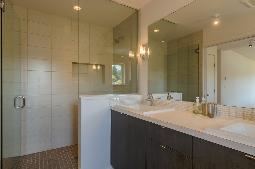 Design ideas for a mid-sized modern master bathroom in Seattle with a drop-in sink, flat-panel cabinets, dark wood cabinets, engineered quartz benchtops, an alcove shower, a two-piece toilet, white tile, glass sheet wall, white walls and porcelain floors.
