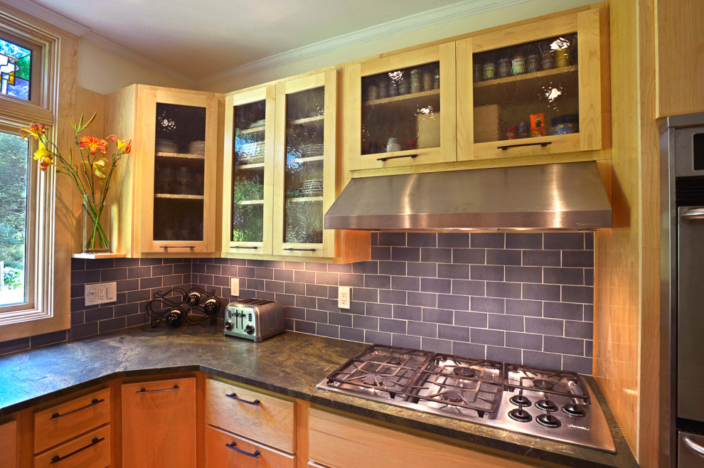 Kitchen - eclectic u-shaped medium tone wood floor kitchen idea in Boston with an undermount sink, glass-front cabinets, light wood cabinets, granite countertops, blue backsplash, ceramic backsplash, stainless steel appliances, no island and green countertops