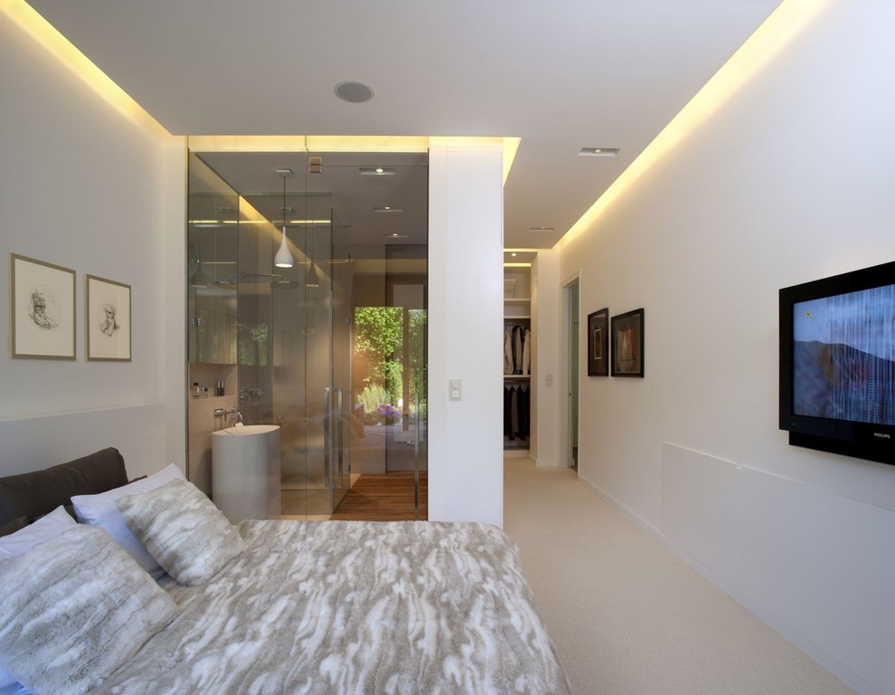 This is an example of a contemporary bedroom with white walls.