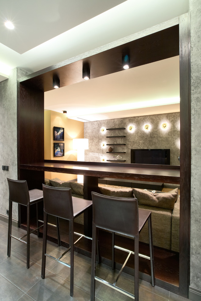Inspiration for a small contemporary l-shaped home bar in Moscow with flat-panel cabinets, medium wood cabinets, composite countertops, brown splashback, stone tiled splashback and porcelain flooring.