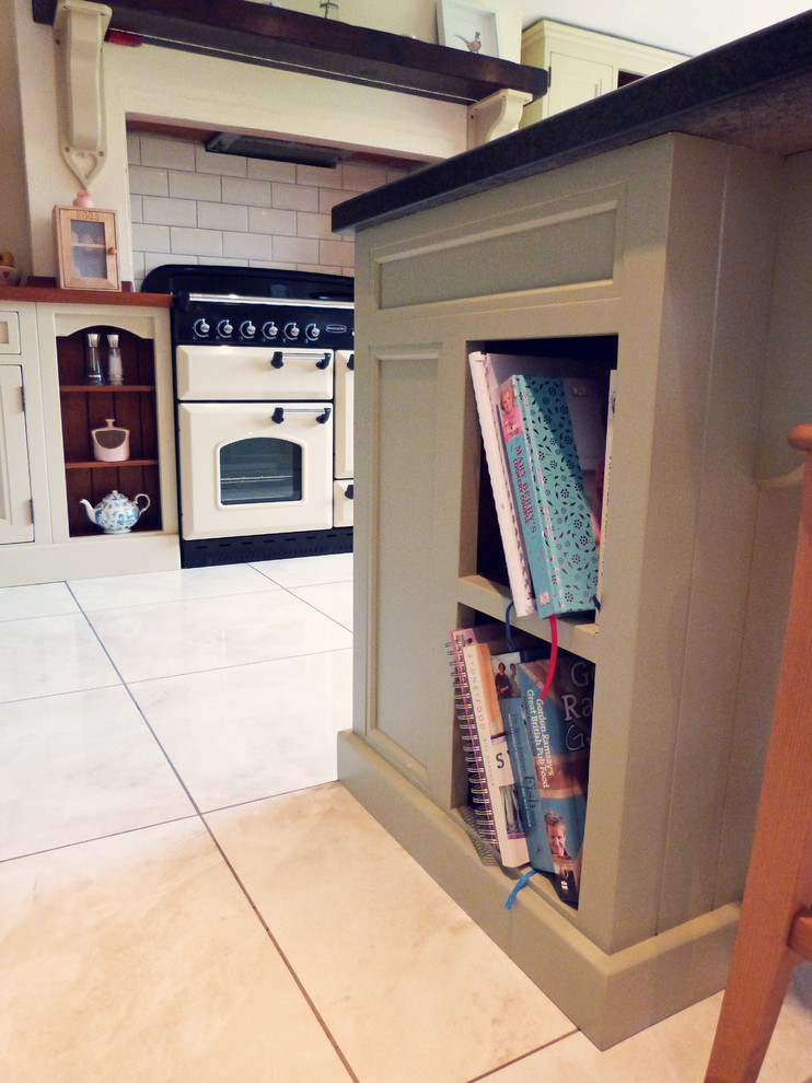 Photo of a rural u-shaped kitchen in Belfast with beige cabinets, wood worktops and an island.