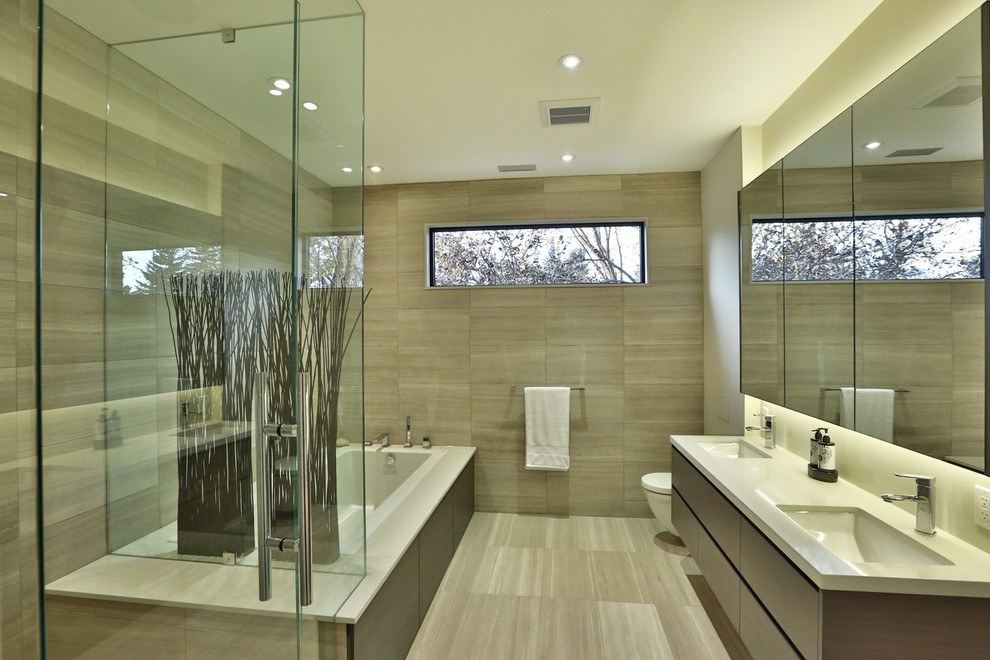 Inspiration for a large contemporary master bathroom in Toronto with flat-panel cabinets, dark wood cabinets, a drop-in tub, a corner shower, a wall-mount toilet, brown tile, porcelain tile, beige walls, porcelain floors, an undermount sink and engineered quartz benchtops.
