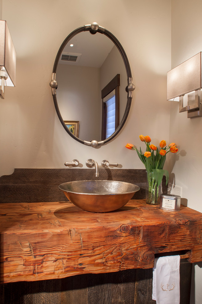 Photo of a country powder room in Denver with white walls, a vessel sink and wood benchtops.