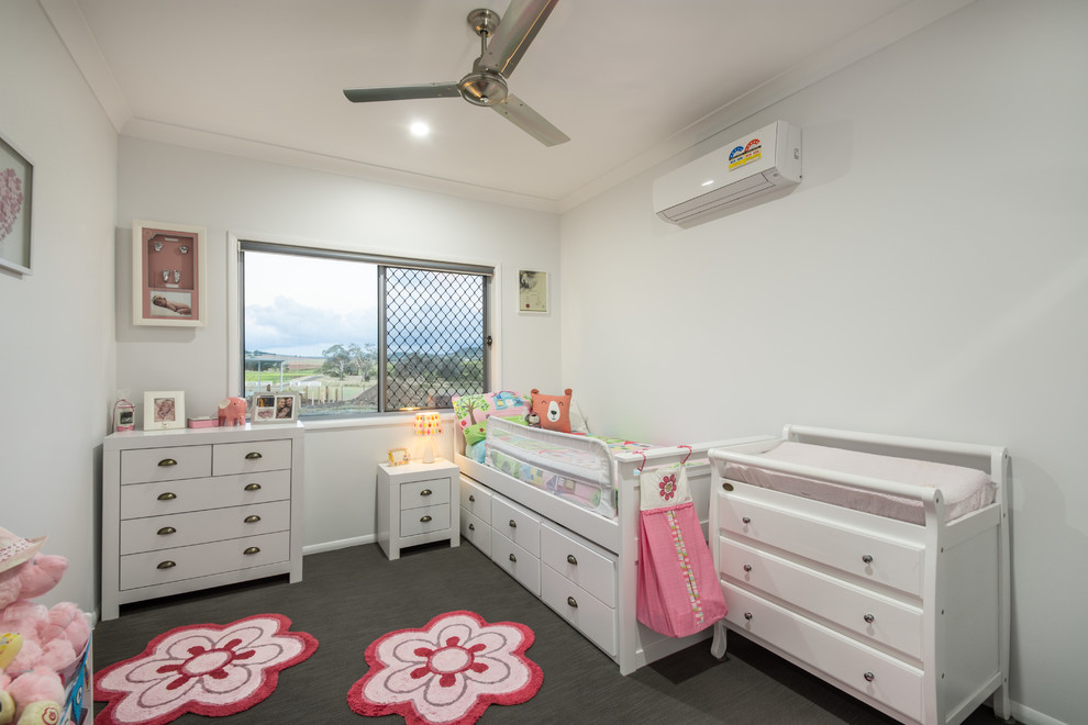 Inspiration for a contemporary nursery for girls in Other with white walls.