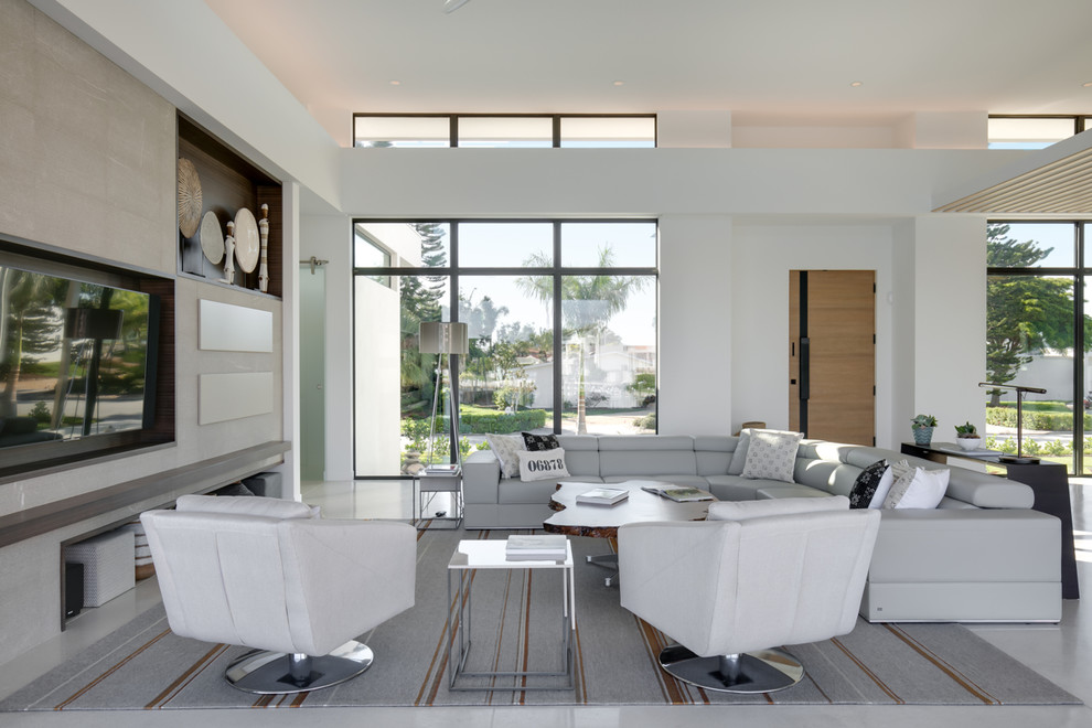 Mid-sized contemporary open concept family room in Tampa with white walls, concrete floors, a built-in media wall and grey floor.