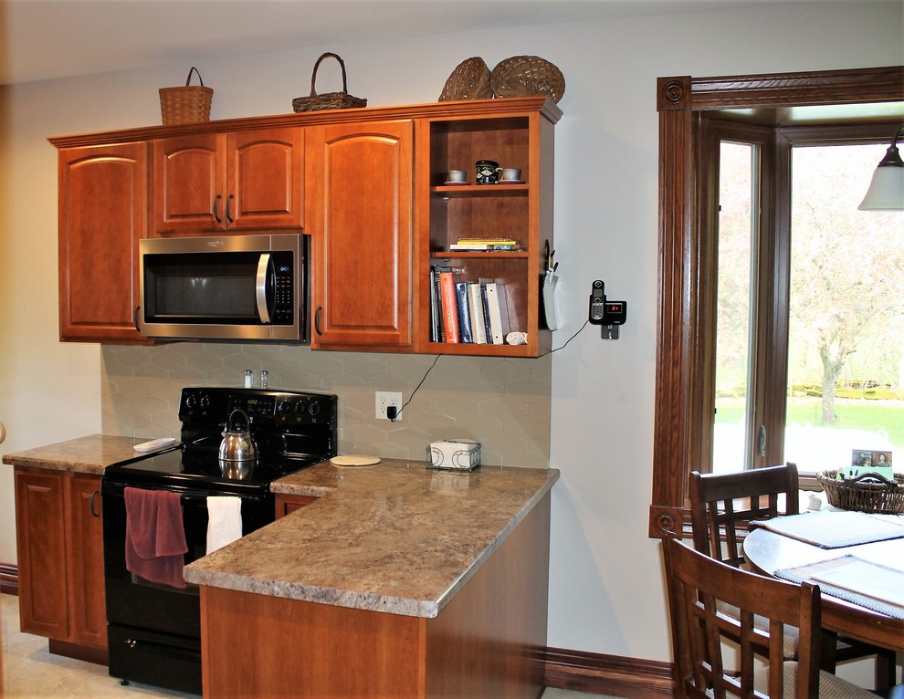Eat-in kitchen - mid-sized rustic l-shaped vinyl floor and beige floor eat-in kitchen idea with a farmhouse sink, raised-panel cabinets, medium tone wood cabinets, laminate countertops, beige backsplash, cement tile backsplash, stainless steel appliances, a peninsula and beige countertops