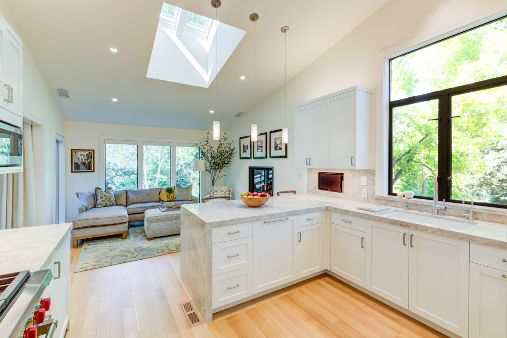 Inspiration for a small transitional u-shaped separate kitchen in San Francisco with shaker cabinets, grey cabinets, quartzite benchtops, beige splashback, stone slab splashback, stainless steel appliances, light hardwood floors, a peninsula, beige floor, beige benchtop and vaulted.