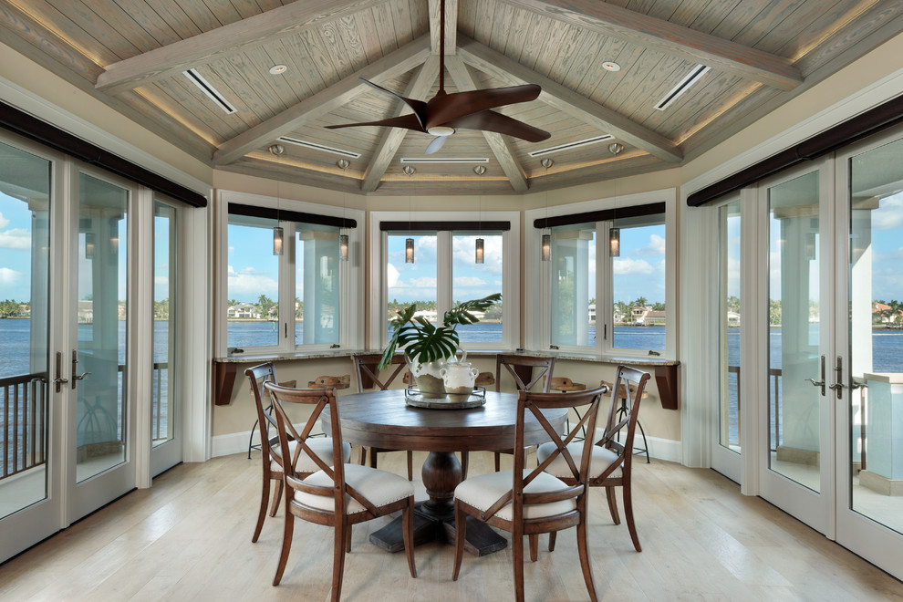 Inspiration for a beach style dining room in Miami with beige walls.