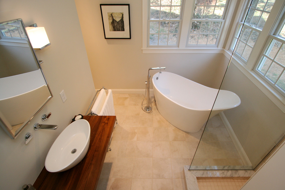 This is an example of a contemporary bathroom in Boston with a vessel sink, a freestanding tub, a corner shower and ceramic floors.