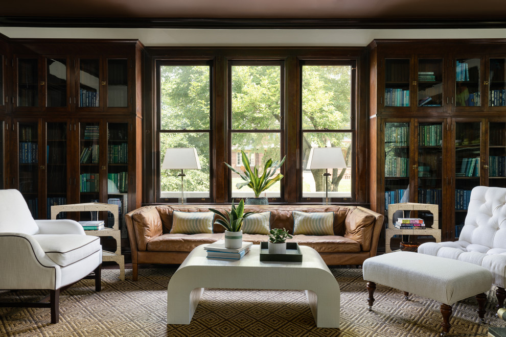 Large eclectic enclosed living room in Columbus with a library, beige walls, dark hardwood floors, a standard fireplace, a brick fireplace surround, no tv and brown floor.