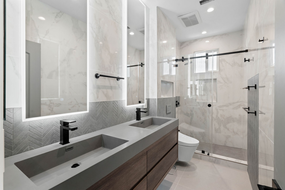 Design ideas for a mid-sized modern kids bathroom in San Francisco with flat-panel cabinets, medium wood cabinets, an alcove shower, a bidet, white tile, porcelain tile, white walls, porcelain floors, engineered quartz benchtops, beige floor, a hinged shower door, grey benchtops, a double vanity and a built-in vanity.