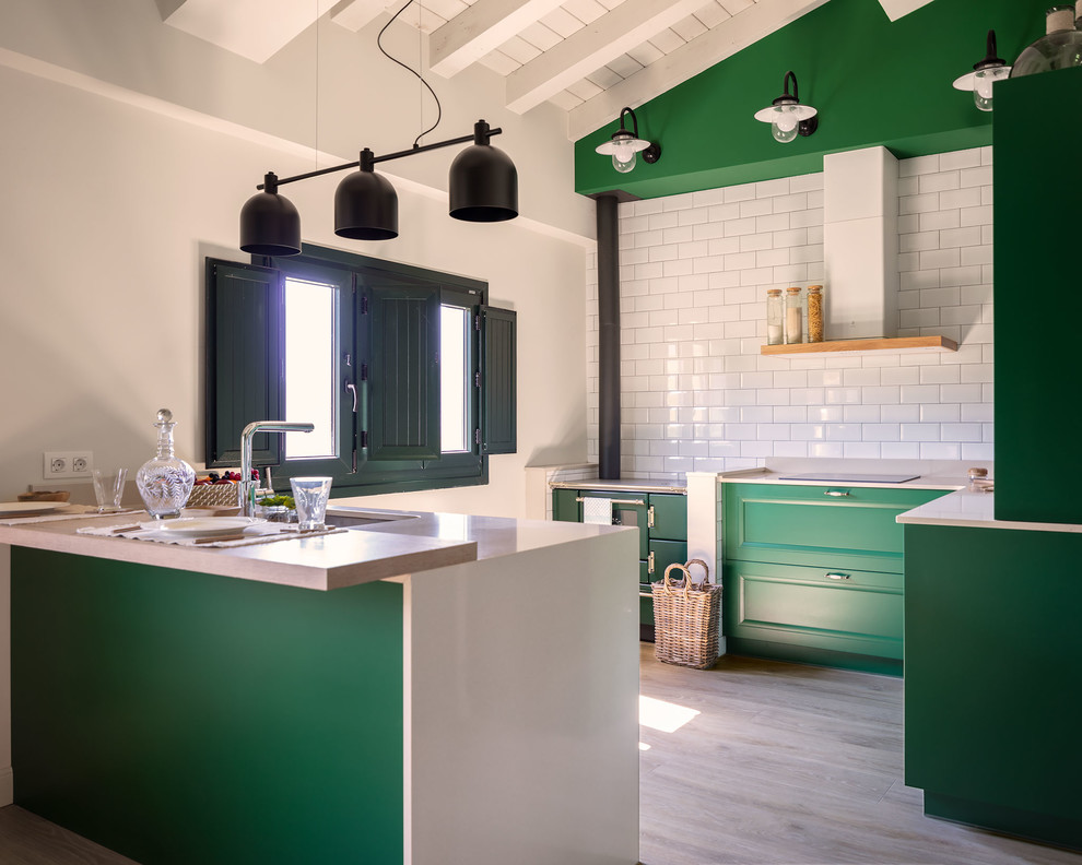 Design ideas for a transitional u-shaped kitchen in Other with an undermount sink, recessed-panel cabinets, green cabinets, white splashback, subway tile splashback, panelled appliances, light hardwood floors, a peninsula, beige floor and white benchtop.