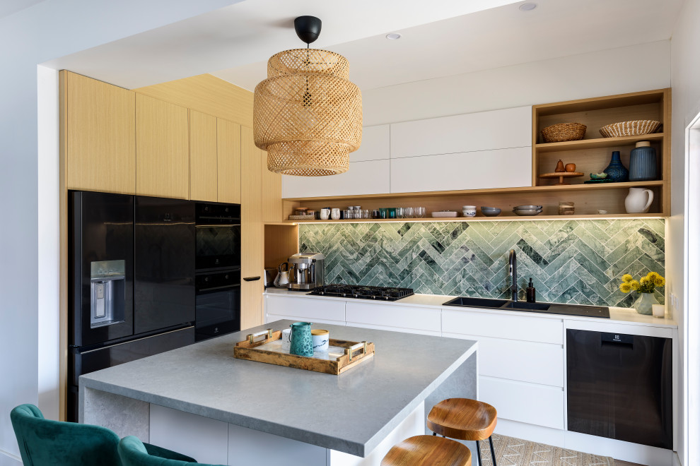 Contemporary kitchen in Newcastle - Maitland with a drop-in sink, flat-panel cabinets, white cabinets, concrete benchtops, multi-coloured splashback, marble splashback, black appliances, with island and grey benchtop.