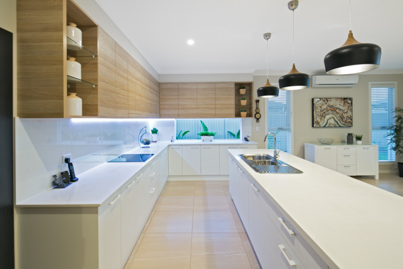 Photo of a large modern eat-in kitchen in Brisbane with a drop-in sink, light wood cabinets, quartz benchtops, white splashback, porcelain splashback, stainless steel appliances, porcelain floors, with island, beige floor and white benchtop.