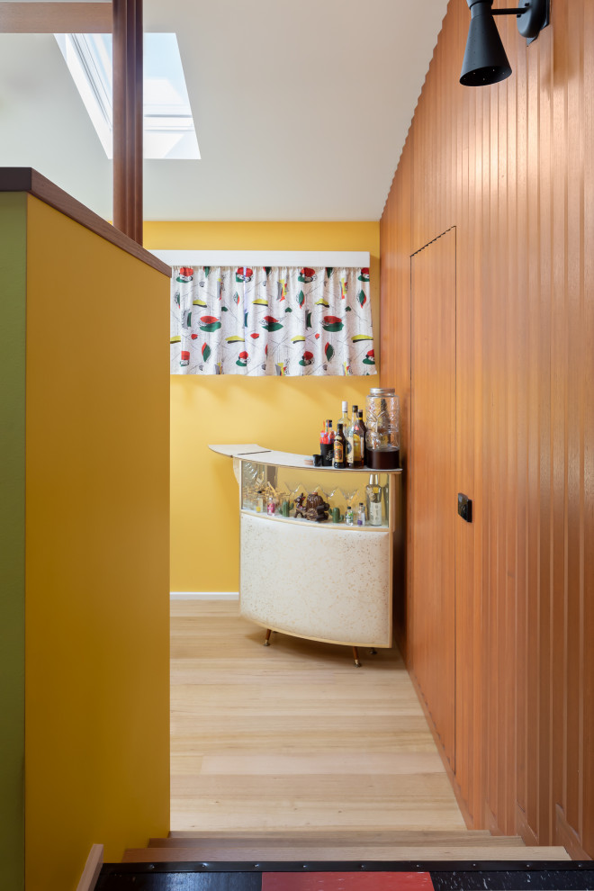 Design ideas for a mid-sized midcentury galley separate kitchen in Melbourne with a single-bowl sink, ceramic splashback, black appliances and multi-coloured floor.