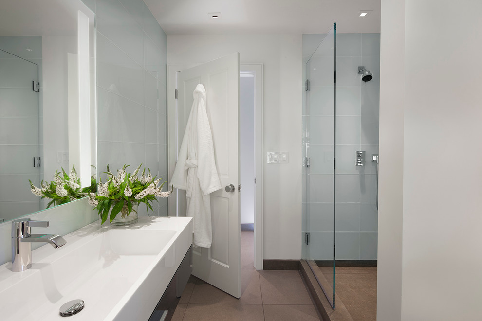 Photo of a mid-sized contemporary master bathroom in San Francisco with blue tile, white walls, ceramic floors, flat-panel cabinets, glass tile, grey cabinets, an alcove shower, a trough sink, engineered quartz benchtops, grey floor and a hinged shower door.