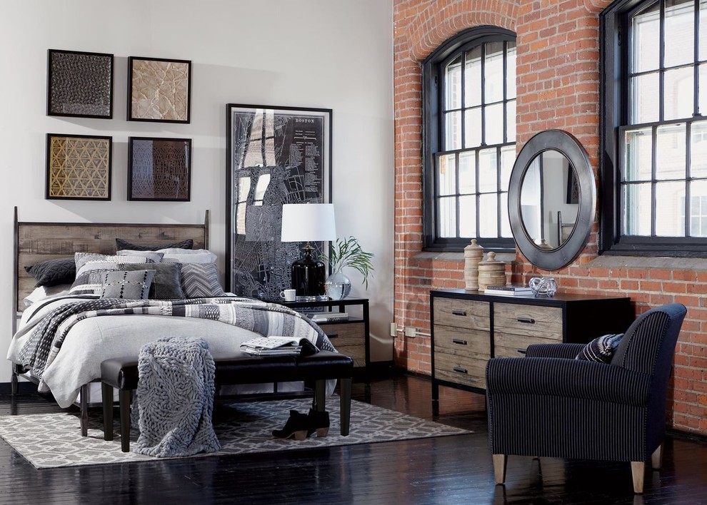 Design ideas for a mid-sized industrial loft-style bedroom in New York with white walls, light hardwood floors, no fireplace and beige floor.