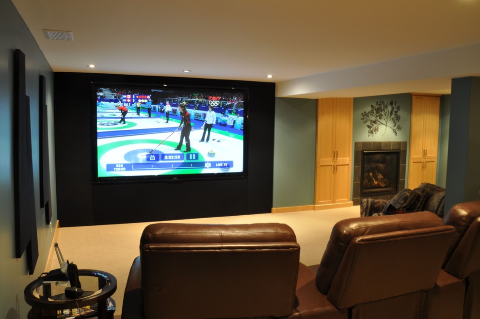 This is an example of a mid-sized contemporary enclosed home theatre in Toronto with blue walls, carpet, a projector screen and beige floor.