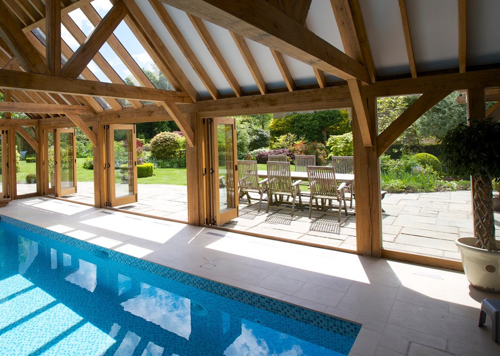 Photo of an expansive country indoor pool in West Midlands with a pool house.