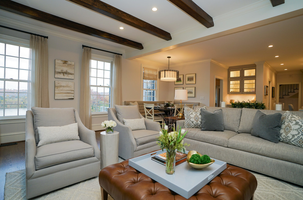 Design ideas for a large traditional formal open concept living room in Other with white walls, medium hardwood floors, a standard fireplace, a wood fireplace surround, a wall-mounted tv and brown floor.