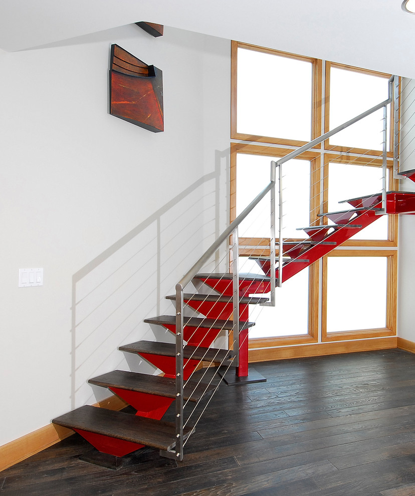 Mid-sized contemporary wood curved staircase in Orange County with open risers.