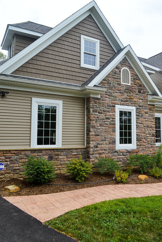 Traditional home style with stone, shingle, and vinyl