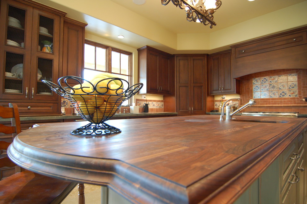 Kitchen - kitchen idea in Phoenix with beaded inset cabinets, medium tone wood cabinets, wood countertops and an island