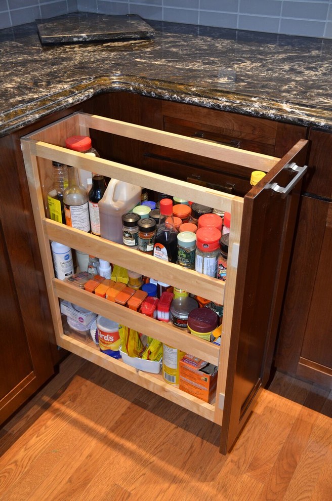 Inspiration for a large transitional l-shaped medium tone wood floor open concept kitchen remodel in Toronto with an undermount sink, recessed-panel cabinets, dark wood cabinets, quartzite countertops, gray backsplash, glass tile backsplash, stainless steel appliances and an island