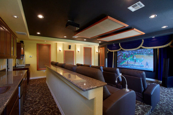Inspiration for a large traditional enclosed home theatre in Cleveland with yellow walls, carpet and a projector screen.