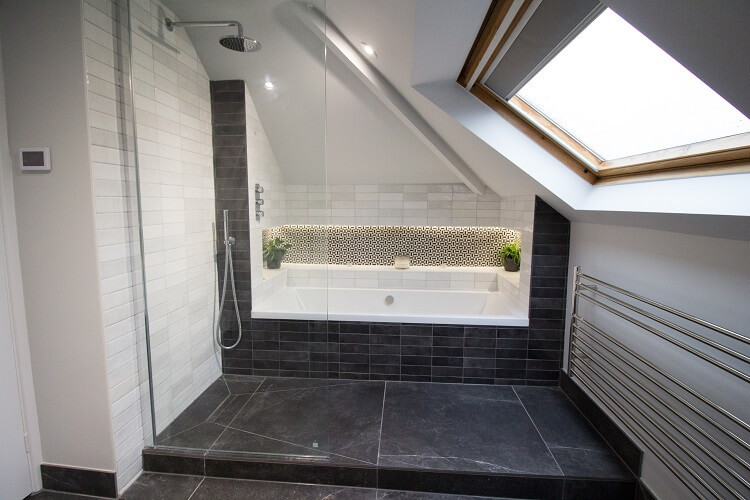 Photo of a medium sized contemporary ensuite wet room bathroom in Other with flat-panel cabinets, white cabinets, a built-in bath, a one-piece toilet, white tiles, white walls, a wall-mounted sink, grey floors, an open shower, white worktops, a feature wall, a single sink and a floating vanity unit.