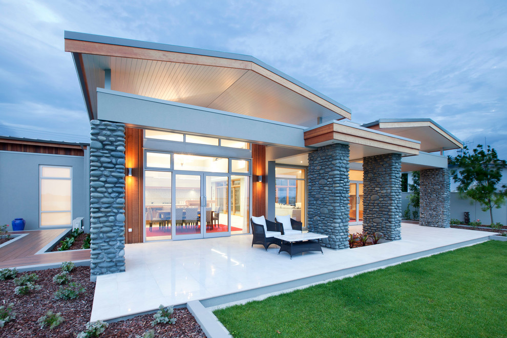 Design ideas for a mid-sized contemporary one-storey exterior in Other with stone veneer.